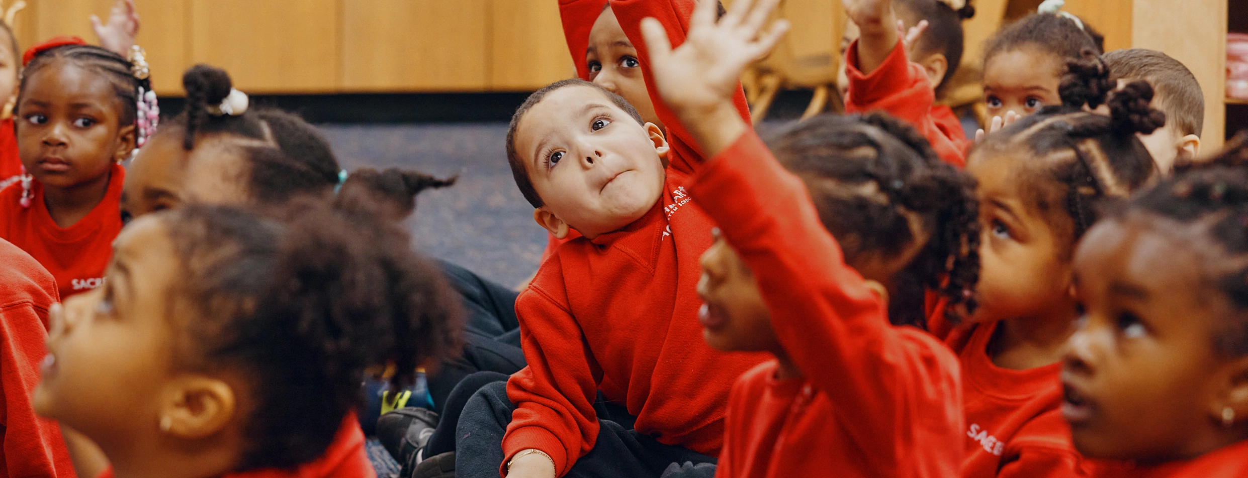 Preschoolers raising hands