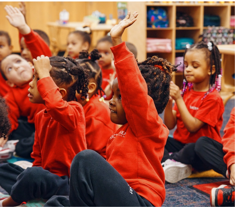 Preschoolers raising hands